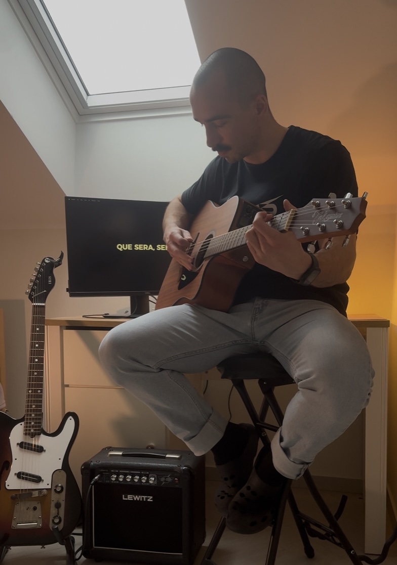 Maros Gorny playing guitar at home