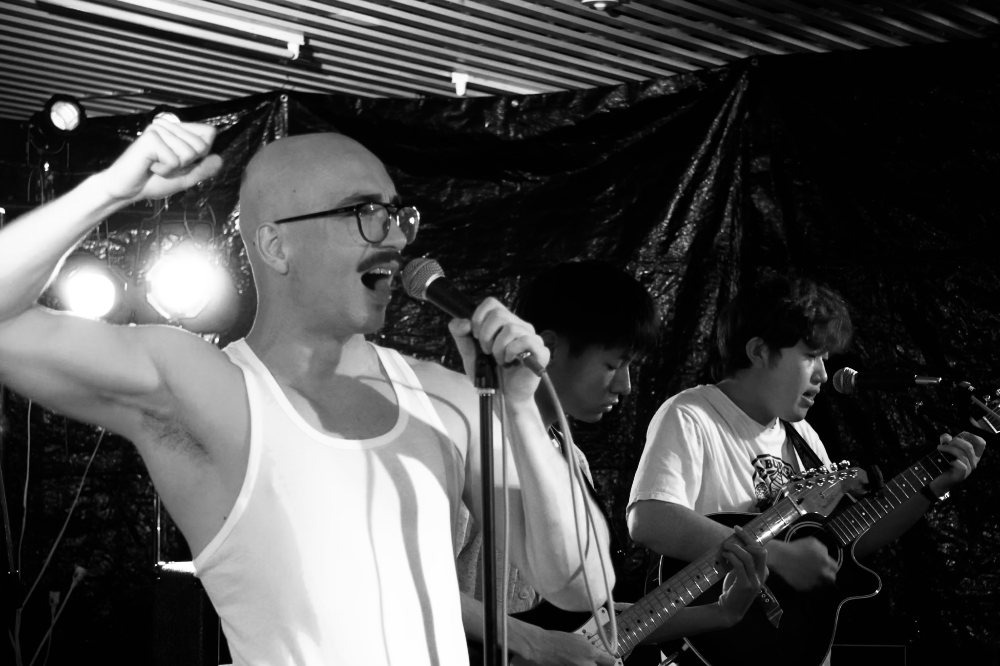 Maros Gorny singing with band members on guitar in Japan